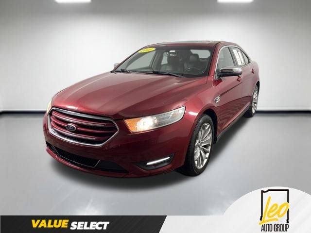 2013 Ford Taurus Limited in Ruby Red Metallic Tinted Clearcoat — front three-quarter view